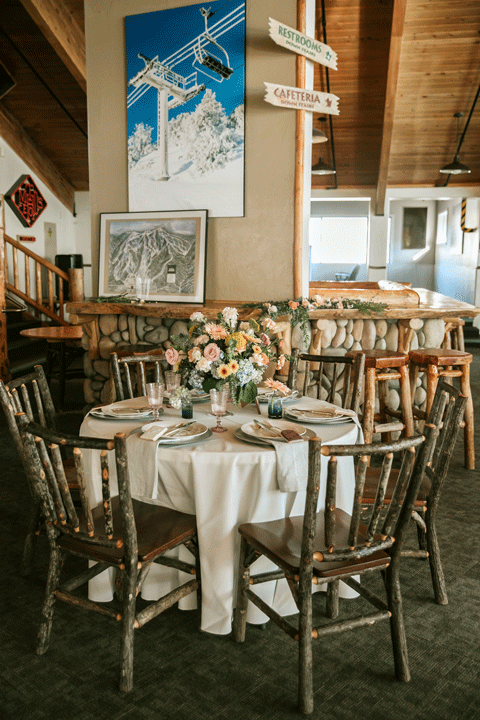 Wedding table setting inside a lodge with ski theme
